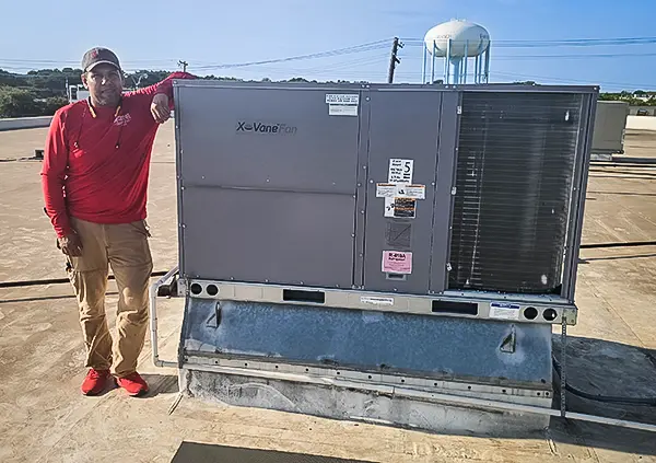 A Fair Comfort Solutions specialist on the roof with a commercial HVAC install.